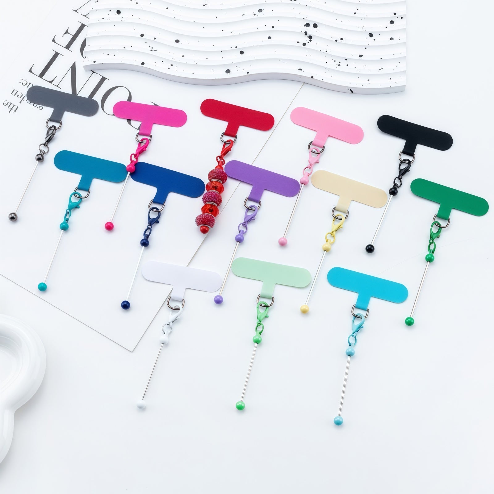Colorful assortment of beadable phone lanyard clips in multiple bright colors for DIY crafting